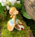 Garden pixie sitting on a mushroom image 0